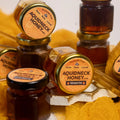 Aquidneck raw wildflower honey in a jar showing natural golden color